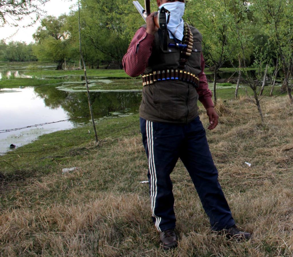 poacher with a gun Afshan poacher hokersar wetland