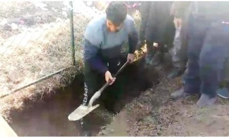 Athar's father while digging grave for his son.