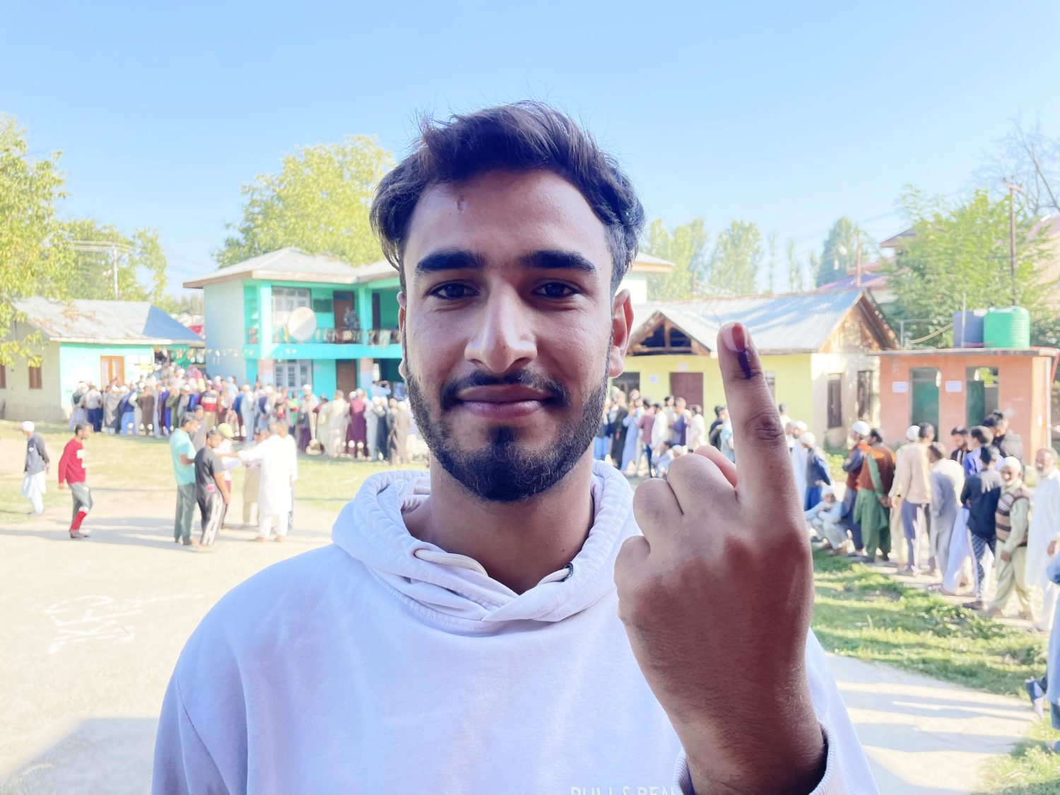 A woman displays ink on her finger after casting her vote in Pulwama, Kashmir on September 18, 2024. [FPK Photo/ Qayoom Khan]